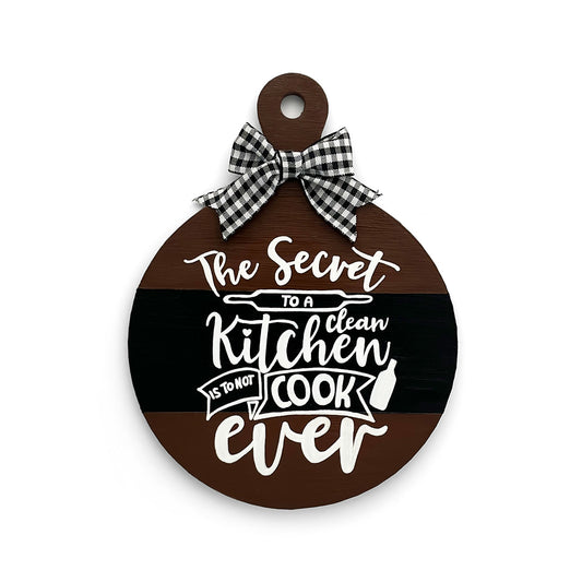 The Secret To A Clean Kitchen Is To Not Cook Ever Hand-Painted Wooden Round Chopping Board Kitchen Wall Hanging - Dark Brown