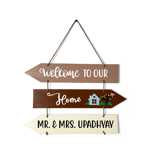Welcome To Our Home Hand-Painted Wooden Three Arrow Plank Name Plate For Home - Brown